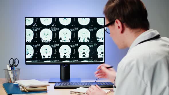 Doctor Examining Xray on Computer Monitor