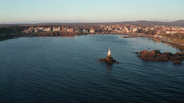 Drone flight at sunrise around the lighthouse in the port of Ahtopol