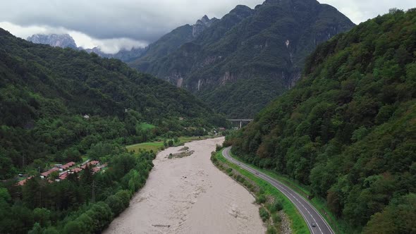 Aerial View of River in the Valley Between Mountains