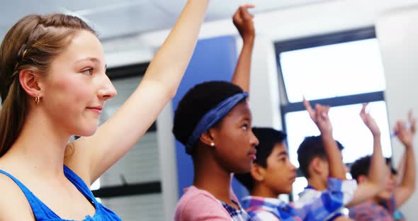 Student raising hand in classroom