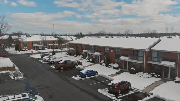 The winter houses from the height the streets and apartment buildings covered with snow