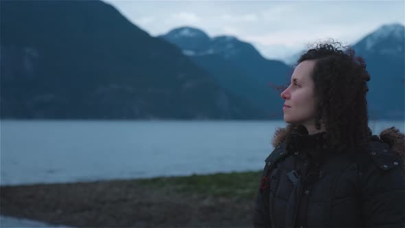 Adventurous Adult Woman Taking in the View of Pacific Ocean Coast