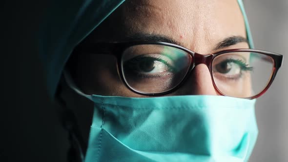 Woman doctor wearing a surgical mask and glasses