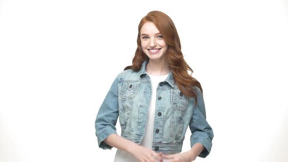 Slow Motion: Portrait Happy Young Caucasian Woman in Denim Making Heart Shape with Hands.