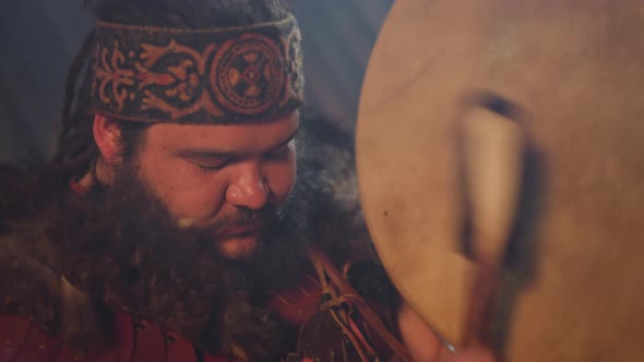 Ecstatic Obese Man Taps Shamanic Drum Doing Old Ritual