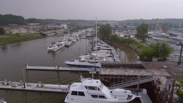 Flying Over Boats Docked at Marina in Glen Cove on a Cloudy Day