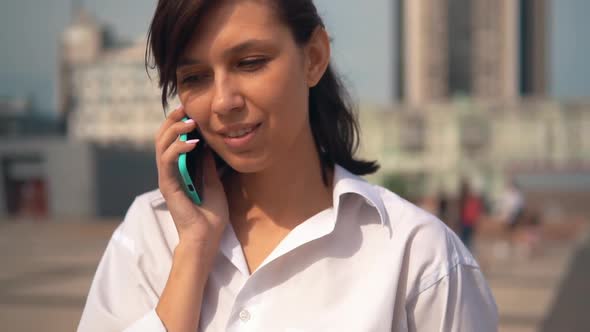 Close Up Young Caucasian Woman Talking By Phone Outdoors