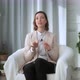 Smiling young woman, blogger, vlogger, influencer, sitting at home, talking, looking at the camera - VideoHive Item for Sale