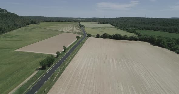 Aerial View of Green Fields and Dry Surrounded By Hills Plants and Mountains