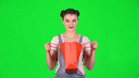 Girl Takes Out Package Then Looks Into It and Is Very Upset on a Green Screen