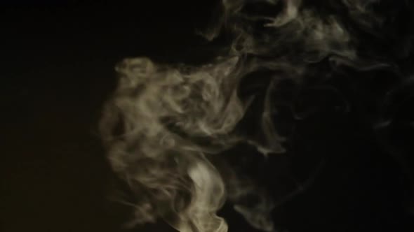 White smoke, fog, mist, vapor on a black background.