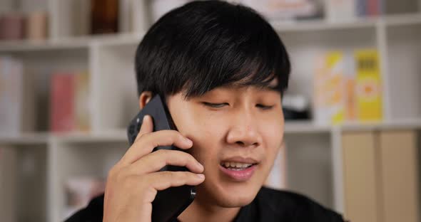 Man talking on mobile phone at home