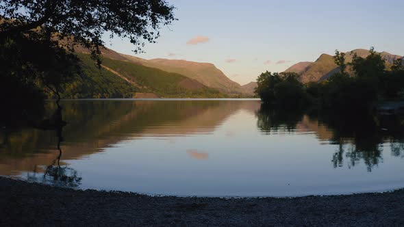 Beautiful Scenery In Llyn Padarn Lake With Water Reflections Of Trees And Mountains Against The Blue