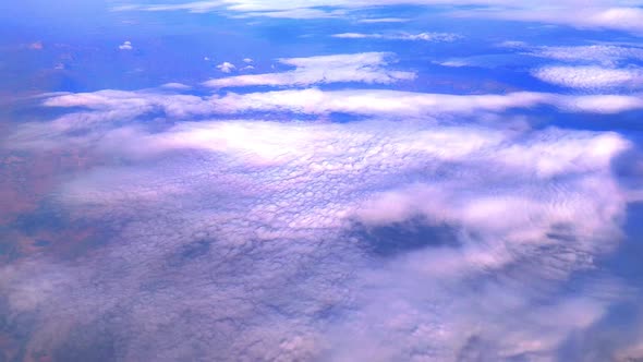 Aerial view of clouds and land beneath it
