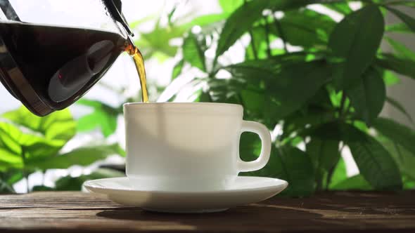 Pour Black Coffee Into a Mug From a Coffee Pot