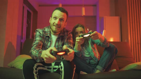 Emotional Diverse Gamers are Holding Joysticks and Competition in Intense Video Game on Gaming