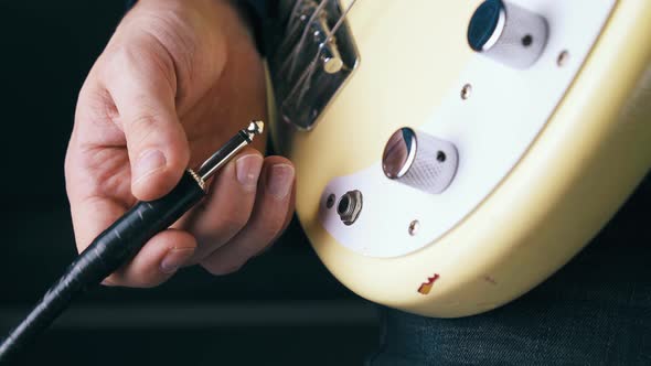 Person Connects Quarter-inch Amplifier Jack To Metal Output