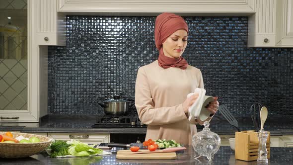 Neat Housewife in Hijab Wipes Dishes Cooking Meal for Supper