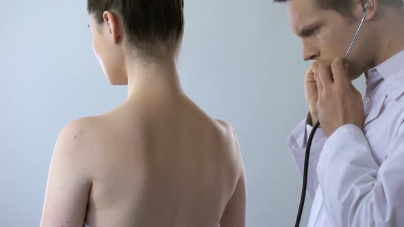 Doctor Taking Stethoscope and Examining Young Woman, Scheduled Hospital Check-Up