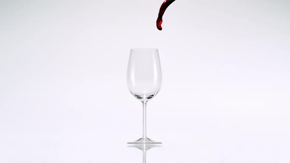 Pouring red wine into glass, Slow Motion