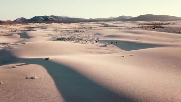 Beautiful desert and dunes view from above with sun and shadows on the sand - amazing nature