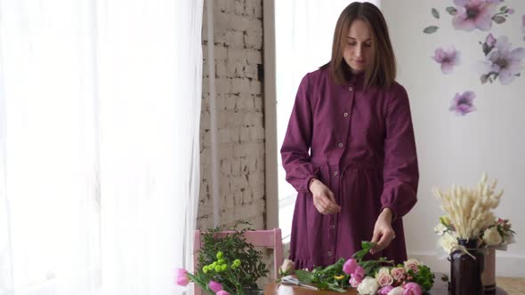 Female Florist's Hands Pruned with Tulle Stalks