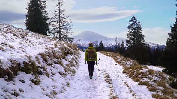 A Woman Travels in the Mountains in Winter