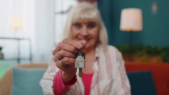 Senior Old Woman Customer Landlord Hold Key to New House Real Estate Owner Make Sale Rental Purchase
