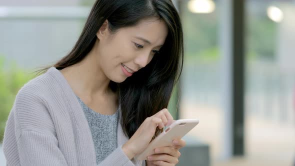 Woman working on mobile phone at outdoor