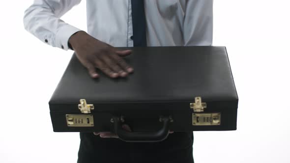 Black Man in a Suit Opens a Suitcase with Dollars