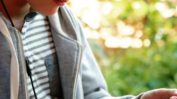 Schoolboy using mobile phone in campus