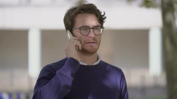 Man Having Phone Conversation on Street