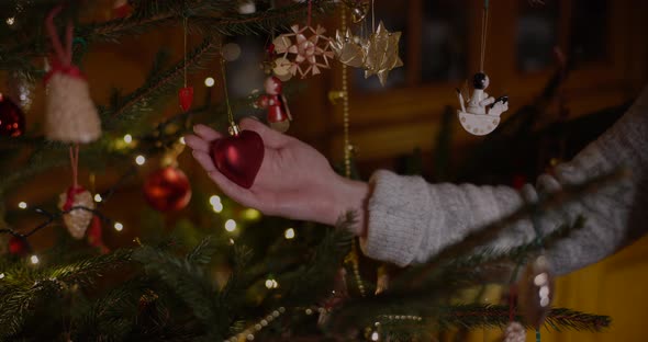 Woman Decorating Christmas Tree at Home