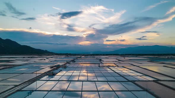 Aerial hyper lapse showing moving clouds over salt fields during golden hour. Phan Rang , Vietnam.