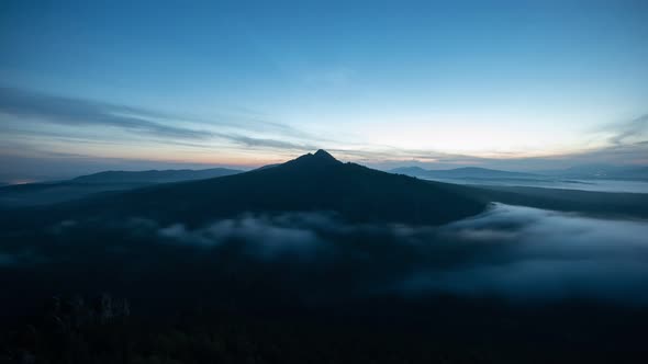 Time Lapse with Cloud River Drifting Along Mountain Peak