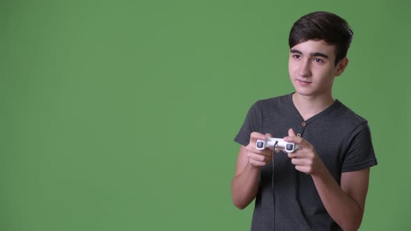 Young Handsome Iranian Teenage Boy Against Green Background