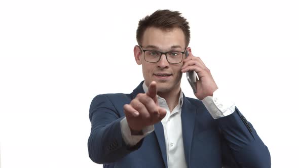 Closeup of Handsome Successful Businessman in Blue Suit and Glasses Talking on Mobile Phone and