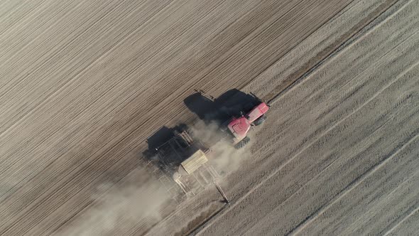 Countryside and Agriculture, Farm Tractors Plow the Earth in Field, Dust in the Field, View From