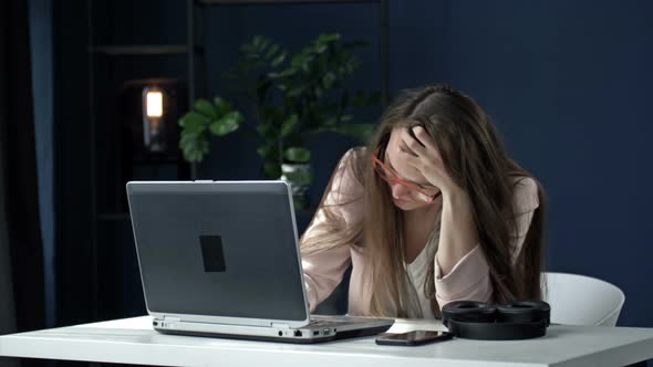 Business Woman Works Late at Night in the Office