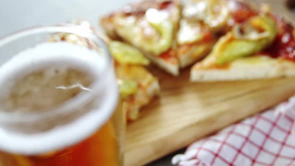 Delicious pizza with a glass of beer