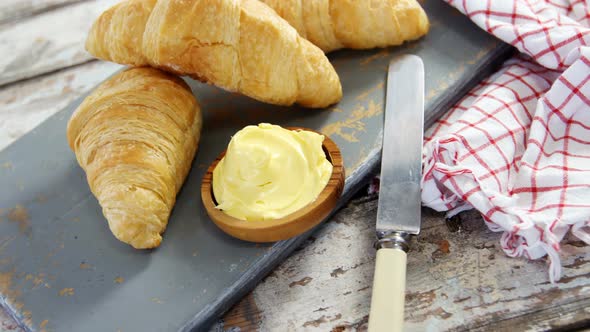 Croissants with butter and knife