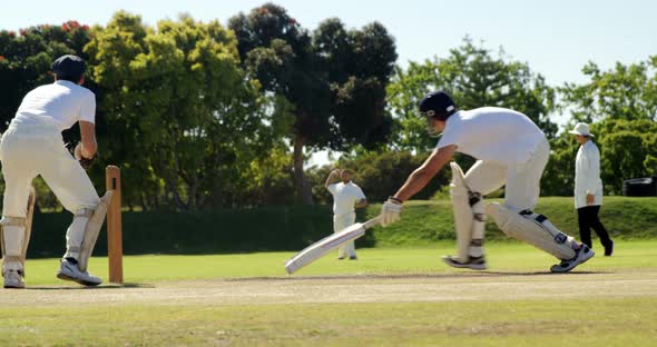 Fielder throwing ball to wicket keeper during cricket match