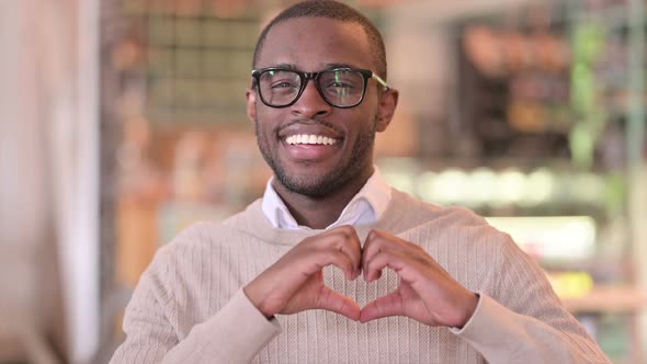 Portrait of Loving African Man Showing Heart Shape with Hand