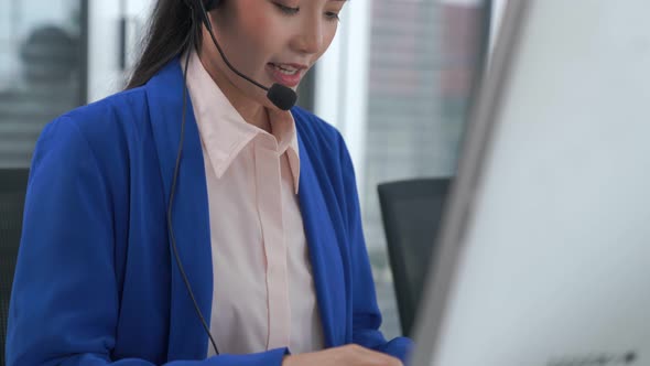 Businesswoman Wearing Headset Working Actively in Office