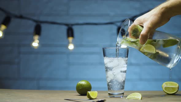 Male hand pouring lemonade