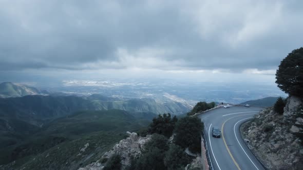 Aerial shot of the valley, drone flies over the winding road near Twin Peaks, California, USA