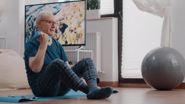 Senior Person Using Dumbbells to Exercise and Train Arms Muscles