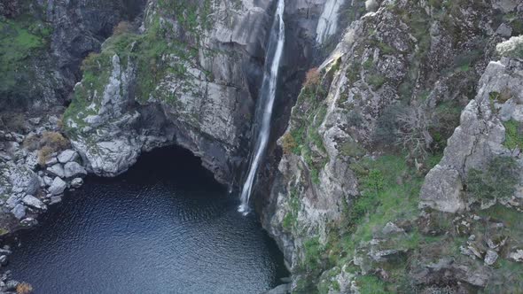 Tilt up waterfall from pool at base to lens flare observation deck