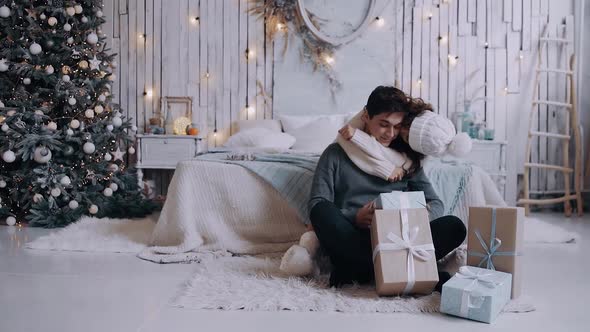 Portrait of a Young Couple Spending Time at Home in the Living Room on Christmas Eve