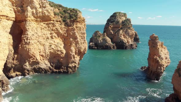 Sea eroded Rocky sprouts scattered along Algarve shore, in Lagos, Portugal